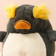 Close up of Jellycat Maurice Macaroni Penguin Soft Toy against neutral coloured background