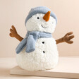 Jellycat Sammie Snowman Soft Toy on top of raised surface with neutral background