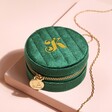 Personalised Quilted Velvet Mini Round Travel Jewellery Case in Green Closed on Beige Surface