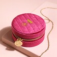 Personalised Quilted Velvet Mini Round Travel Jewellery Case in Pink Closed On Beige Surface 