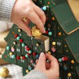 Model putting chocolate inside drawer of Personalised Fill Your Own Christmas Tree Advent Calendar