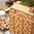 Birdseye view of Personalised Wooden Gingerbread House LED Advent Calendar showing roof of calendar next to gingerbread men