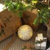 Ceramic LED Celestial Ball Light under Christmas tree
