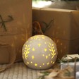 Ceramic LED Celestial Ball Light under Christmas tree with presents