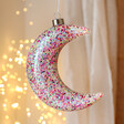 Hanging Pink Glitter LED Moon Light Hanging with String Lights in the Background