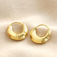 Gold Sterling Silver Faceted Dome Huggie Hoop Earrings on top of beige coloured fabric