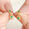Gold Sterling Silver Green Crystal and Malachite Sun Drop Earrings held by model in front of neutral white background