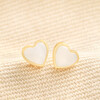 Gold Sterling Silver Mother of Pearl Heart Stud Earrings on Beige Fabric
