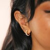 Close Up of Gold Sterling Silver Mother of Pearl Huggie Hoop Earrings on Model