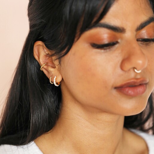 Model Wearing Earrings Model Wearing Gold Sterling Silver Mother of Pearl Huggie Hoop Earrings