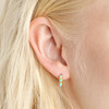 Close up of blonde model wearing Gold Sterling Silver Teal Stone Huggie Hoop Earrings