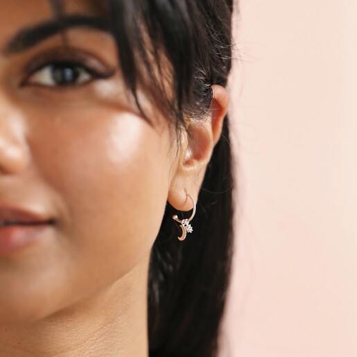 Sterling Silver Moon and Star Charm Hoops on model in front of neutral coloured backdrop