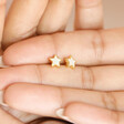 Model holding Mother of Pearl Star Stud Earrings in Gold in palm of hand
