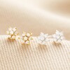 Sterling Silver Crystal Flower Stud Earrings with gold studs on top of neutral coloured fabric