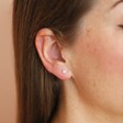 Sterling Silver Crystal Flower Stud Earrings on model against peach coloured backdrop