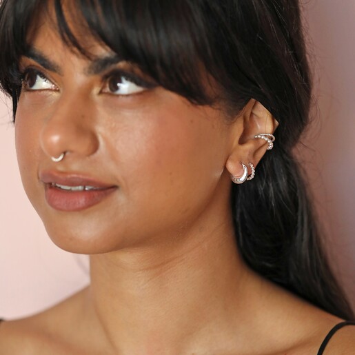 Model looking up wearing curated look with Sterling Silver Faceted Dome Huggie Hoop Earrings