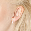 Close up of model wearing Sterling Silver Small Domed Hoop Earrings