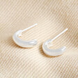 Sterling Silver Small Domed Hoop Earrings laid out on neutral coloured fabric
