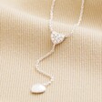 Sterling Silver Crystal Heart Lariat Necklace close up on beige fabric