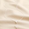 Sterling Silver Crystal Heart Lariat Necklace full length on neutral coloured fabric