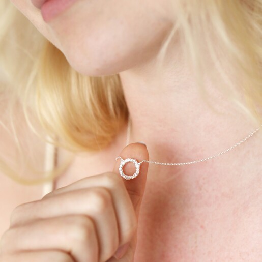 Model wearing Sterling Silver Crystal Hoop Pendant Necklace and holding pendant up with thumb