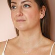Model looking forward wearing Sterling Silver Pastel Crystal Horizontal Bar Necklace in front of beige coloured backdrop