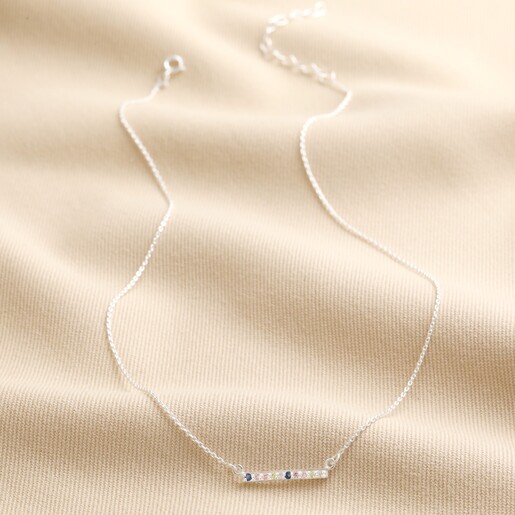 Sterling Silver Pastel Crystal Horizontal Bar Necklace laid on top of beige coloured fabric