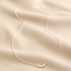 Sterling Silver Tiny Triplet Heart Bar Necklace full length on top of neutral coloured material