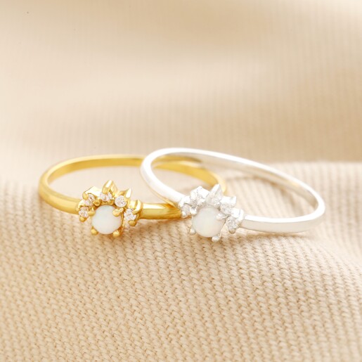 Gold Sterling Silver Crystal and Opal Cluster Ring laid on beige fabric with silver version