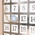 Close up of magnetic counter on Festive Metal House Advent Calendar