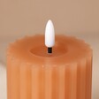 Close up of LED Flame on Pink Ribbed Wax LED Pillar Candle