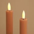 Close Up of Flame on Set of Two Pink Ribbed Wax LED Dinner Candles