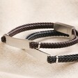 Men's Double Braided Leather Bracelet in Brown with black version on top of neutral coloured fabric