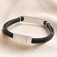 Back of Men's Double Braided Leather Bracelet in Black showing clasp on top of beige coloured fabric