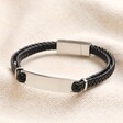 Men's Double Braided Leather Bracelet in Black on top of beige coloured fabric