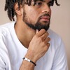 Model wearing Men's Double Braided Leather Bracelet in Black with hand on chin