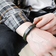 Men's Khaki Thick Woven Leather Bracelet on model holding band of bracelet