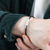 Model wearing Men's Leather Cord and Bar Bracelet in Black with wrist in hand