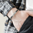 Men's Navy Antiqued Woven Leather Bracelet on model with hand in pocket