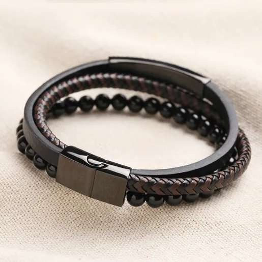 Back of Men's Onyx Bead and Leather Triple Layered Bracelet showing clasp on top of beige coloured fabric