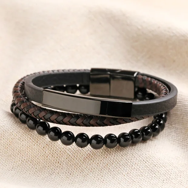 Men's Onyx Bead and Leather Triple Layered Bracelet Men's Onyx Bead and Leather Triple Layered Bracelet on top of beige coloured fabric