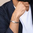 Close up of Men's Stainless Steel Black Cord Curb Chain Bracelet on model