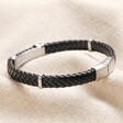 Side of Men's Stainless Steel Feature Braided Leather Bracelet in Black showing mini stainless steel features on top of beige coloured material