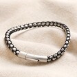 Men's Stainless Steel Silver and Black Ball Chain Bracelet on top of beige coloured fabric