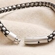 Close up of clasp on Men's Stainless Steel Silver and Black Ball Chain Bracelet on top of neutral coloured fabric