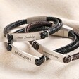 Personalised Men's Double Braided Leather Bracelets stacked on top of each other on top of beige coloured fabric