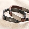 Personalised Men's Double Leather Bracelets with black and brown stacked on top of beige fabric