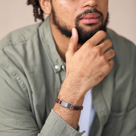 Bracelet on Model Personalised Men's Double Leather Bracelet in brown on model with hand on chin