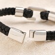 Close up of clasp on Stainless Steel Hook Feature Braided Leather Bracelet in Black open on top of neutral coloured material