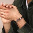 Stainless Steel Hook Feature Braided Leather Bracelet in Black on model with hands clasped together